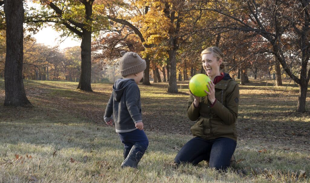 Coach Nina playing ball with her son