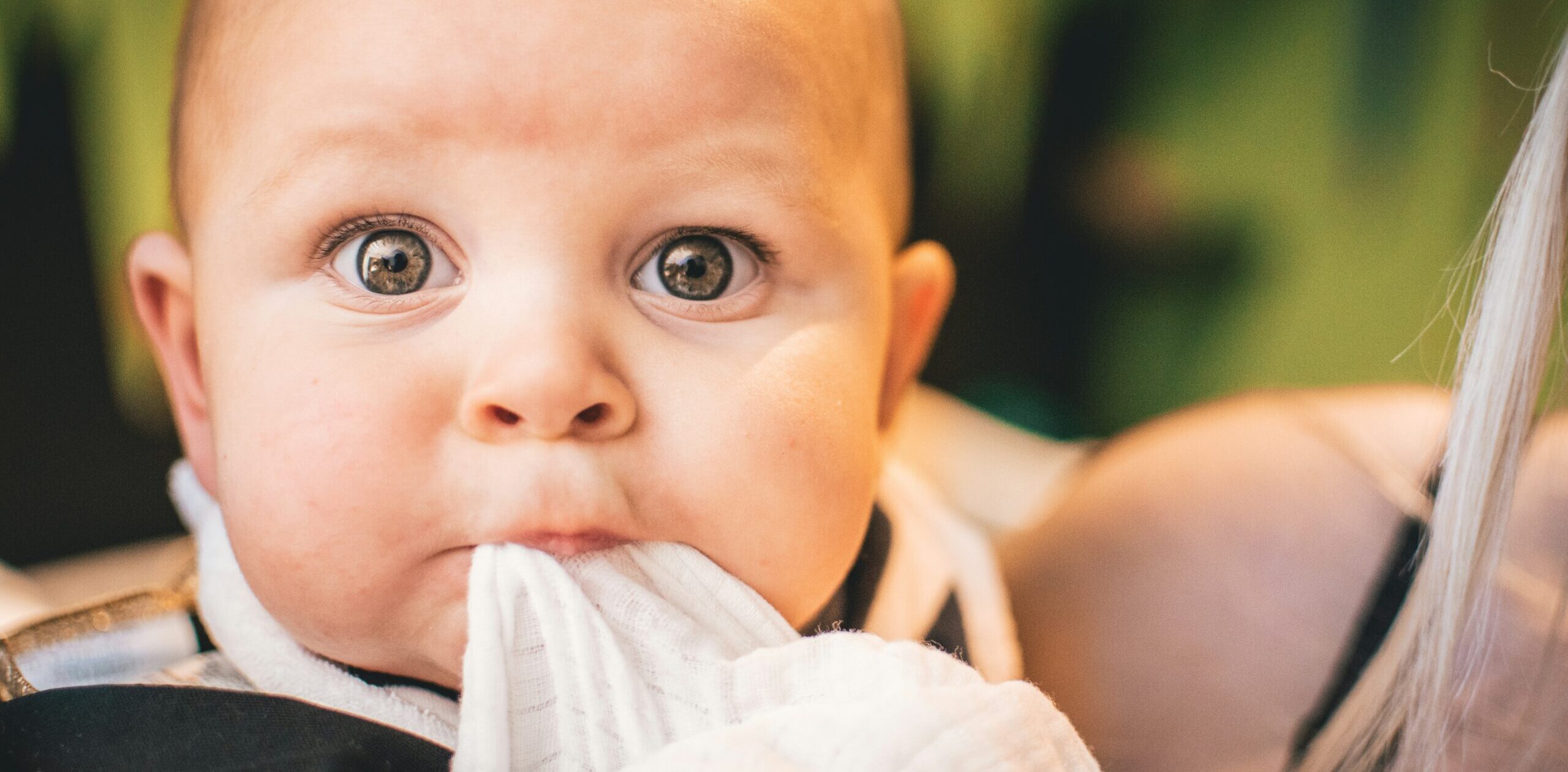 baby chewing on cloth