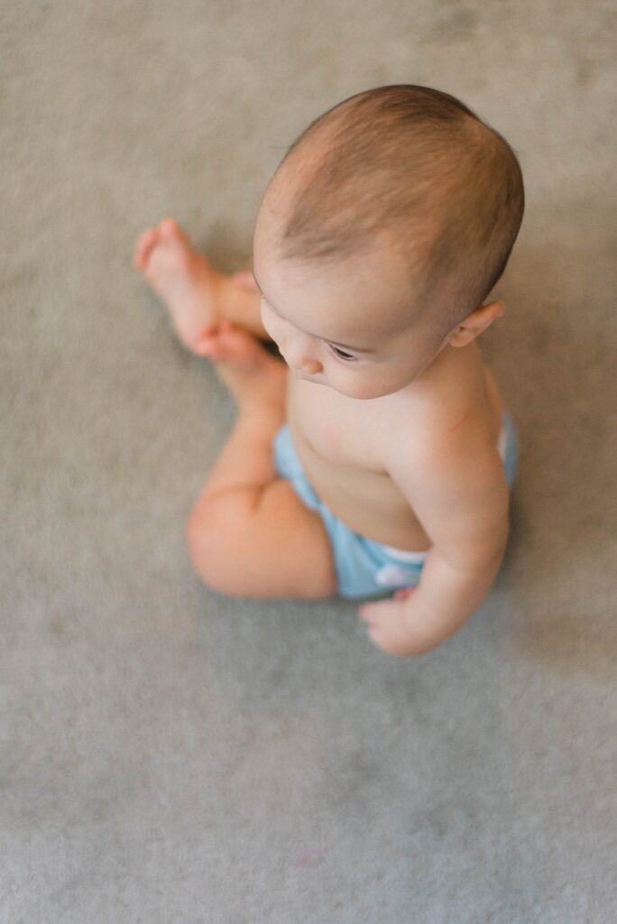 sitting baby photographed from above